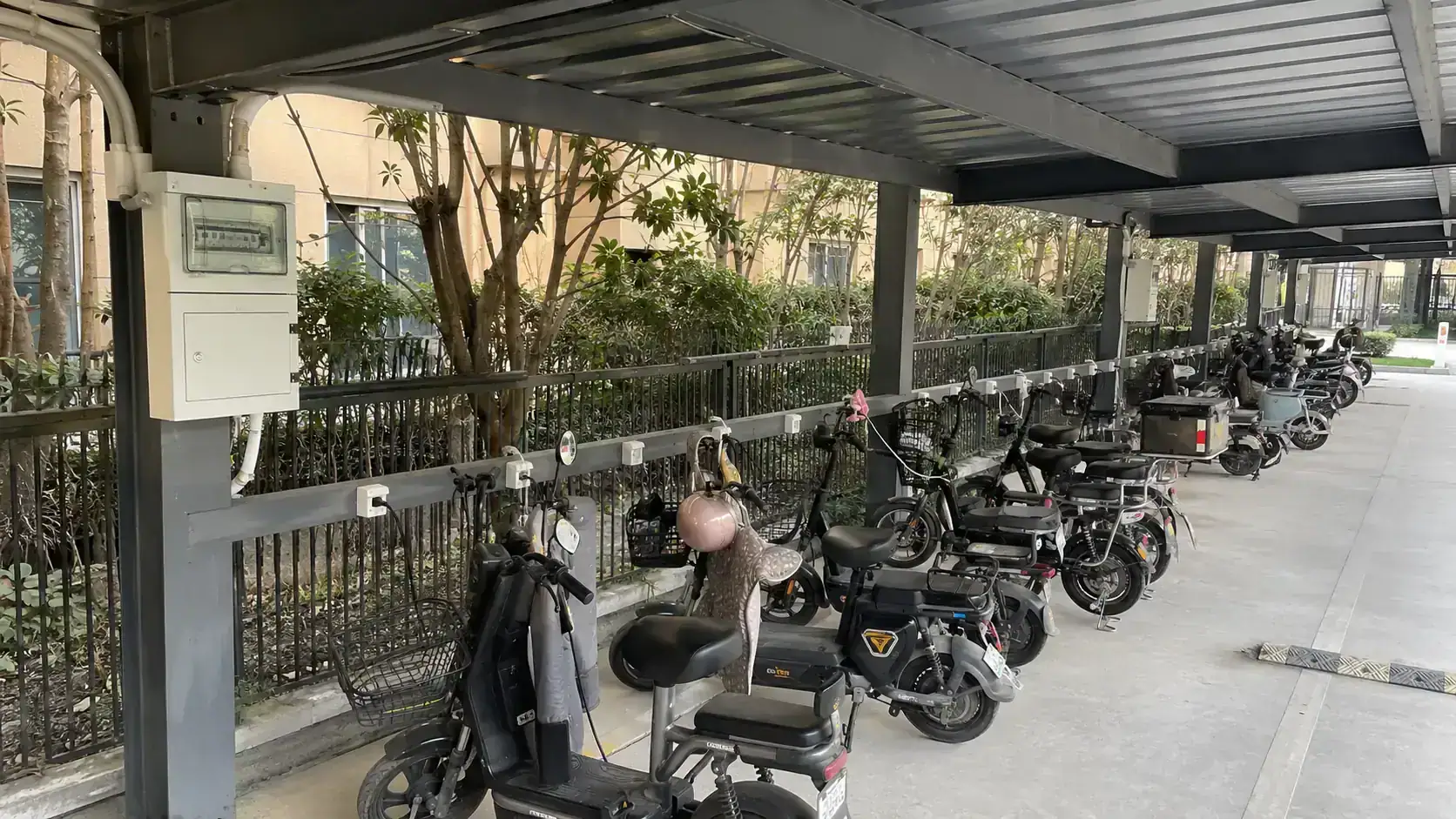 Residential e-bike charging area under a steel canopy